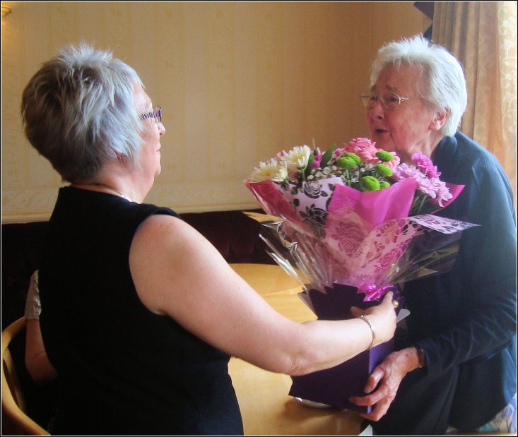 Mary presenting bouquet to Helen Mary presenting bouquet to Helen